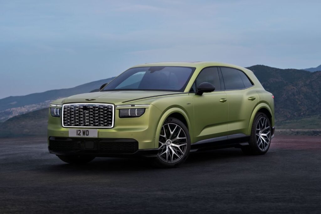 Front three-quarter view of the green Bentley Torcal electric SUV, showing its illuminated diamond-pattern grille and distinctive headlights.