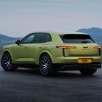 Rear three-quarter view of the green Bentley Torcal electric SUV, featuring slim LED taillights and large alloy wheels.