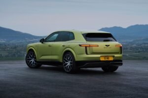 Rear three-quarter view of the green Bentley Torcal electric SUV, featuring slim LED taillights and large alloy wheels.