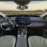 BMW iX4 interior dashboard featuring the central touchscreen and Panoramic iDrive display.