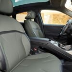 Front cabin of the BMW iX4 showing the seats, centre console and contemporary interior finishes.
