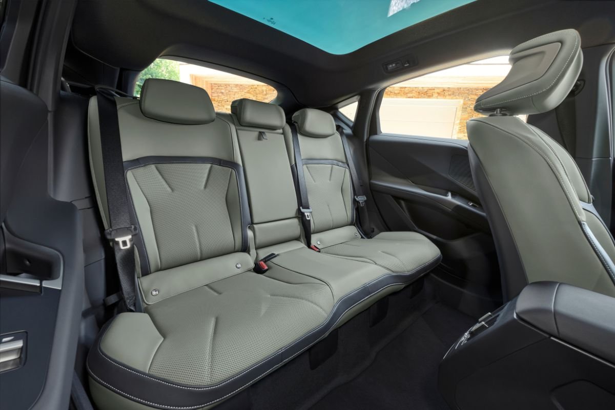 BMW iX4 rear passenger compartment showing the rear seats and interior space. BMW iX4 rear passenger compartment showing the rear seats and interior space.