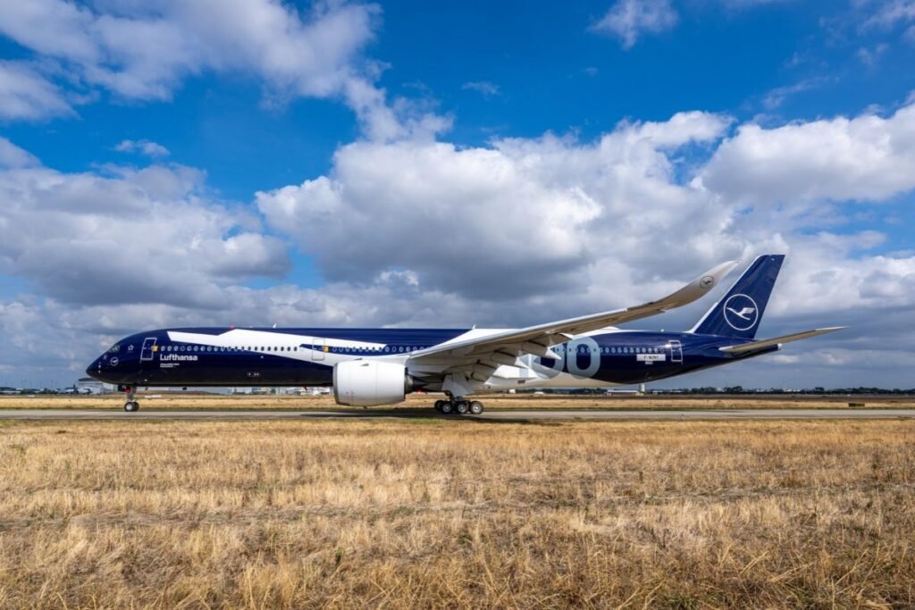 Lufthansa Airbus A350-1000 aircraft featuring the airline's blue and white 100th anniversary livery, photographed on an airport runway.