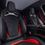 Mercedes-AMG GT SUV front sports seats with black upholstery, red accents and integrated AMG branding.