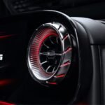 Close-up of the Mercedes-AMG GT SUV turbine-style dashboard air vent with red ambient lighting.