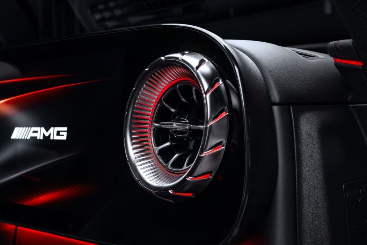 Close-up of the Mercedes-AMG GT SUV turbine-style dashboard air vent with red ambient lighting.