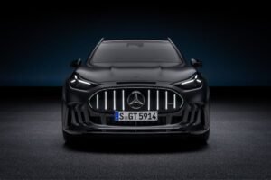 Front view of the black Mercedes-AMG GT SUV with illuminated vertical grille bars and LED headlights.