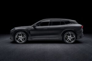 Side profile of the black Mercedes-AMG GT SUV showing its sculpted bodywork, roofline and alloy wheels.