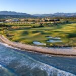 Aerial view of Verdura Resort's coastal golf course, Mediterranean shoreline and surrounding Sicilian landscape.