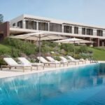 Contemporary Sicilian villa with a large outdoor swimming pool, sun loungers and landscaped Mediterranean gardens.