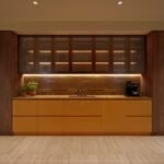 Modern kitchen design featuring illuminated glass cabinets, wood panelling and a stone worktop.