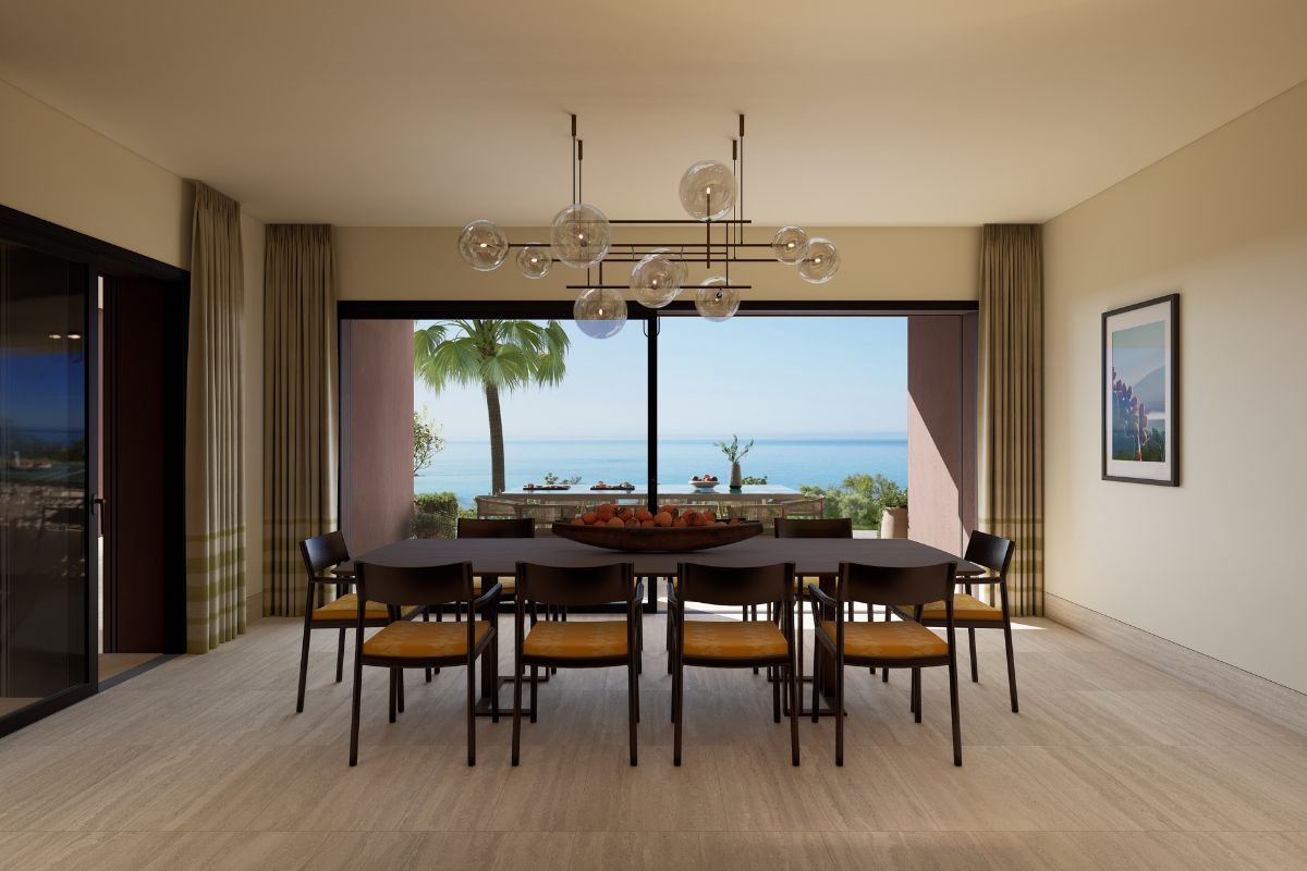 Elegant villa dining room with a contemporary chandelier and large glass doors overlooking the Mediterranean Sea.