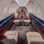 SyberJet SJ36 cabin concept with cream leather seats, red seatbelts and blue and red ambient lighting.