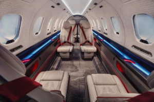 SyberJet SJ36 cabin concept with cream leather seats, red seatbelts and blue and red ambient lighting.