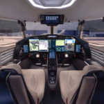 SyberJet SJ36 SyberVision cockpit showing digital flight displays, pilot controls and panoramic windscreen.