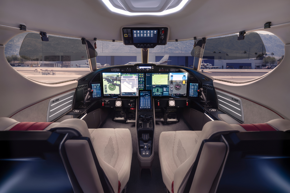 SyberJet SJ36 SyberVision cockpit showing digital flight displays, pilot controls and panoramic windscreen.